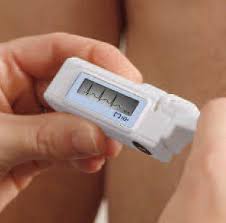 Portable Holter monitor device displaying heart rhythm on a patient